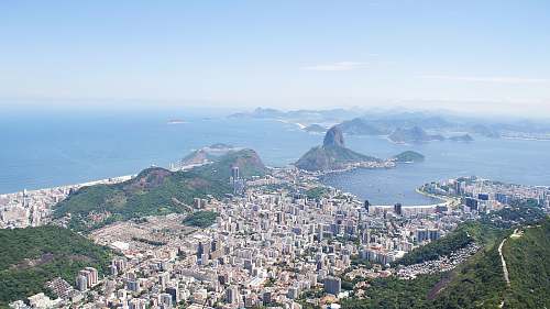 nature aerial photography of city near body of water at daytime landscape